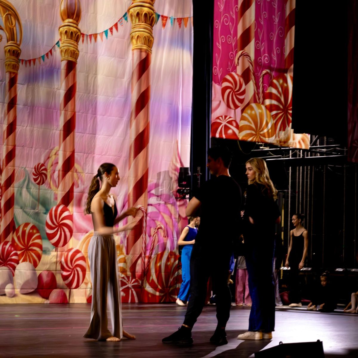 Ballet instructors Reilly Daggett and Julio Concepcion talk with a performer during a dress rehearsal.