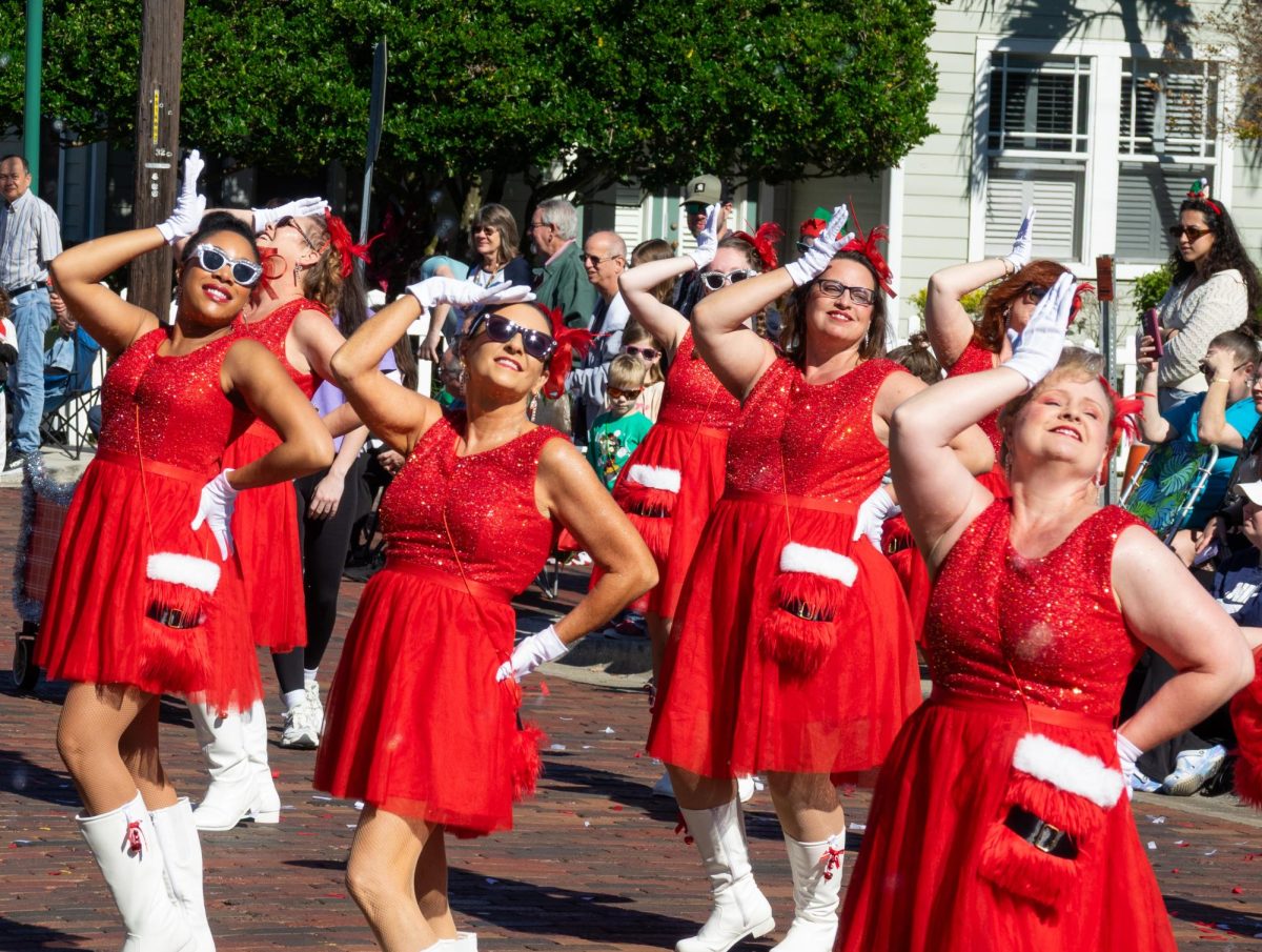 Women dressed in Christmas costumes perform a choreography during Largo's annual holiday parade. 