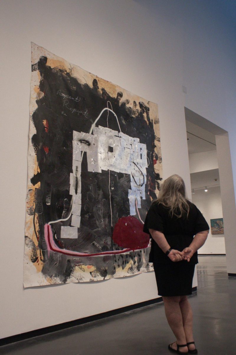 Cindy Stovall, a longtime Creative Pinellas employee, examines a piece by Jason Hackenwerth at the Arts Annual 8 in January.